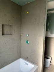 A bathroom with a bathtub and a shower.