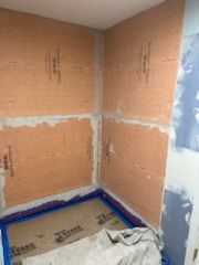A bathroom is being remodeled and the walls are being painted.