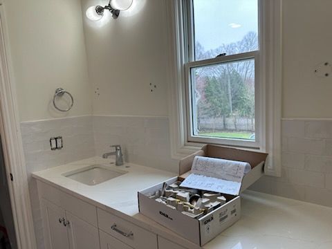 A bathroom with a sink and a box on the counter.