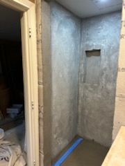 A shower stall is being built in a bathroom.