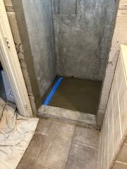 A shower stall is being remodeled in a bathroom.