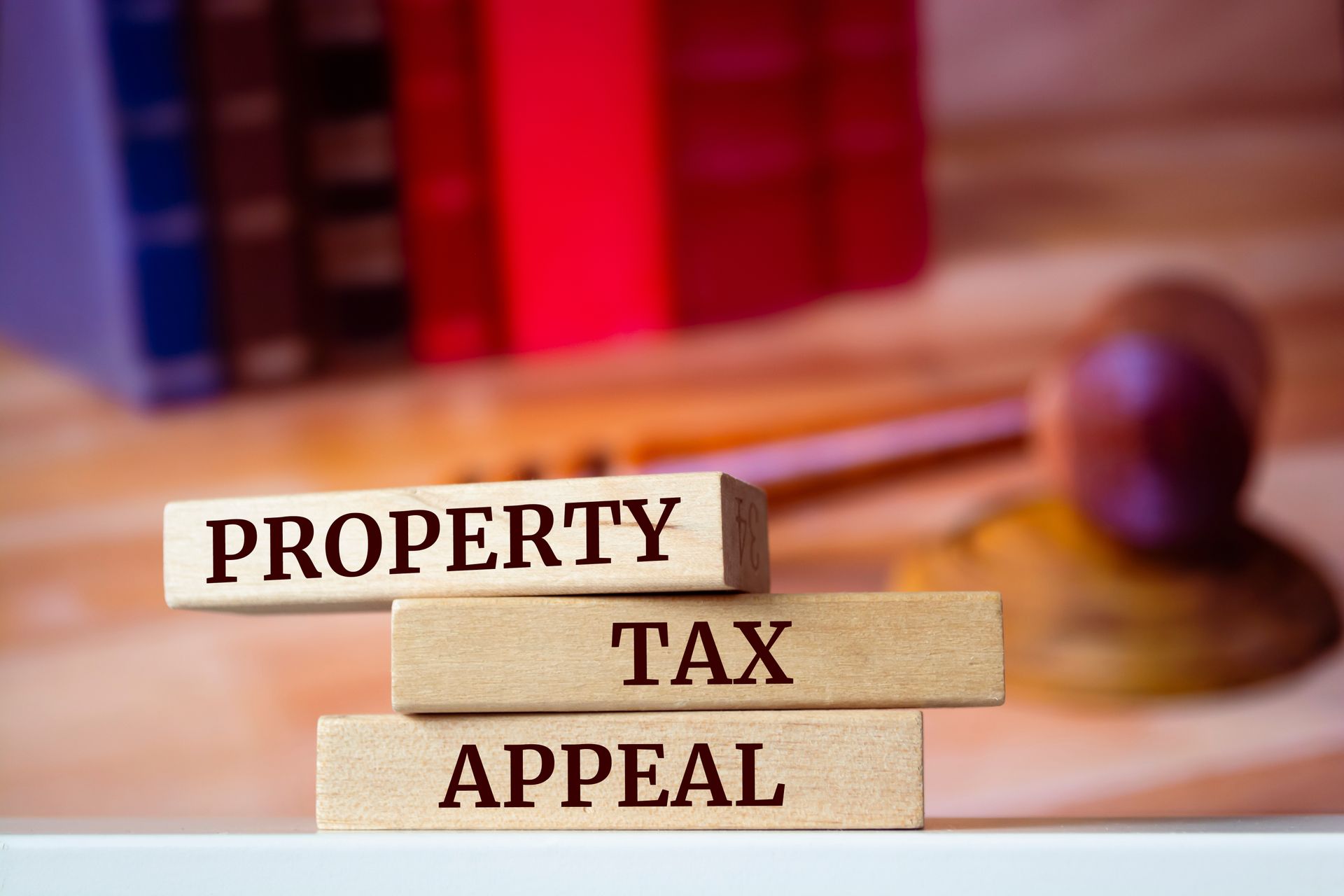 Property tax appeal blocks with gavel in background.