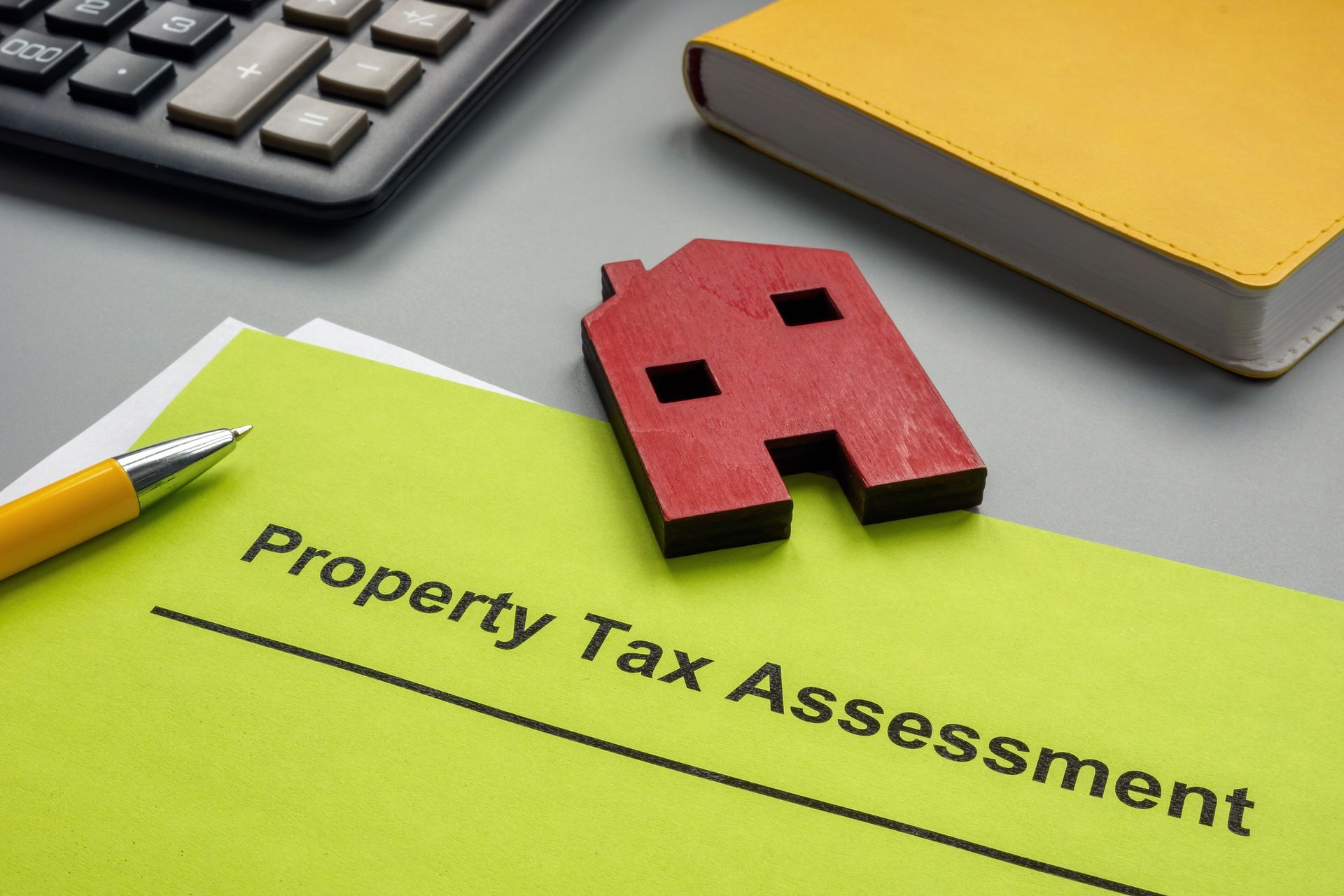Property tax assessment papers and model of house Property tax assessment papers and model of house