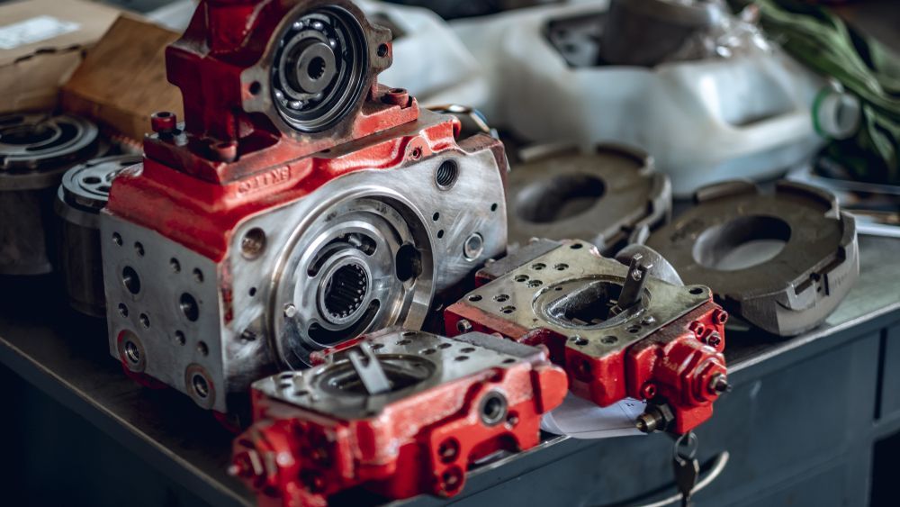 Disassembled Red and Silver Industrial Machinery on a Workbench — Elite Fleet Auto in Cannonvale, QLD