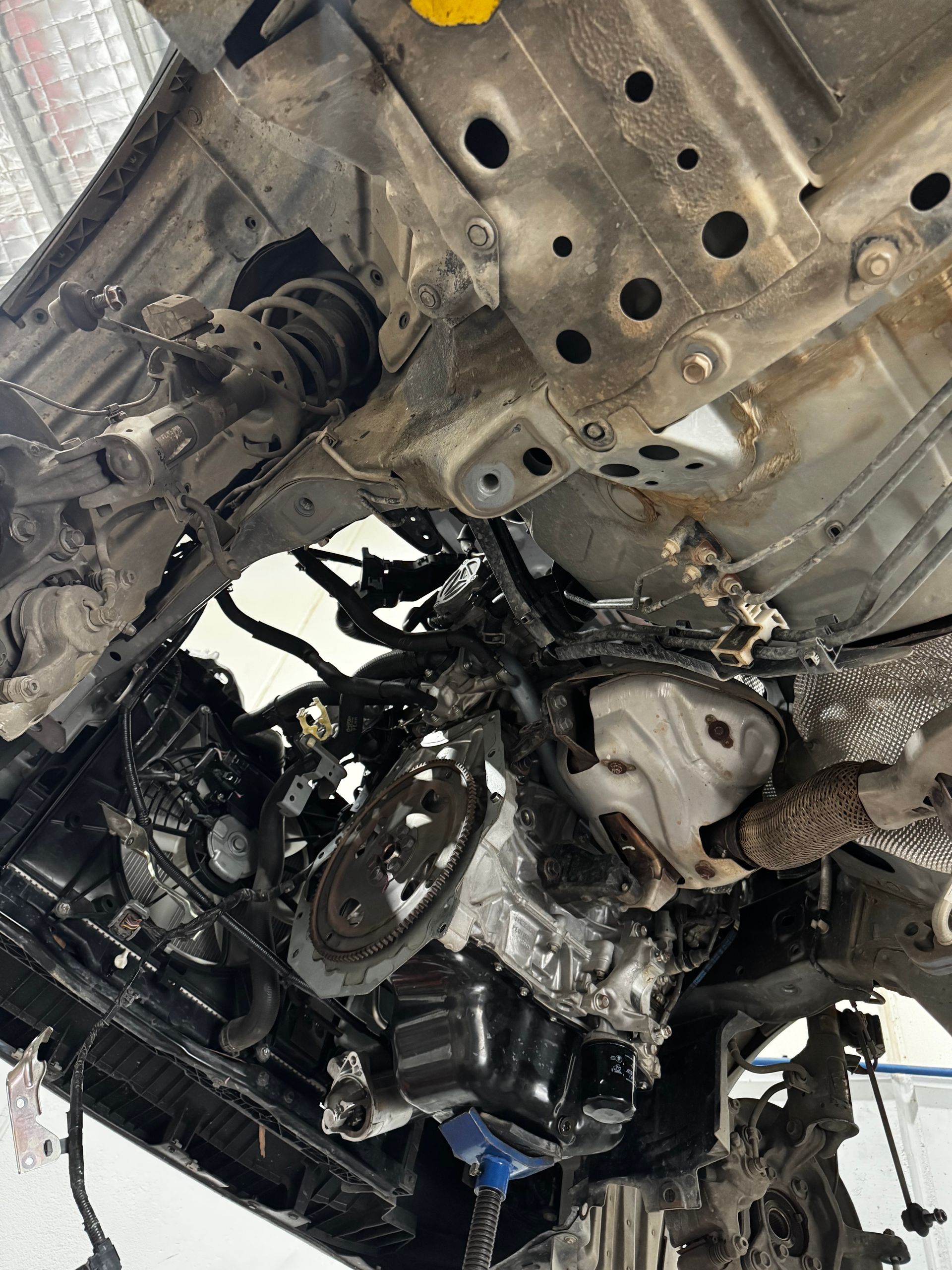 An Underside View Of A Vehicle Lifted In A Garage — Elite Fleet Auto in Mackay, QLD
