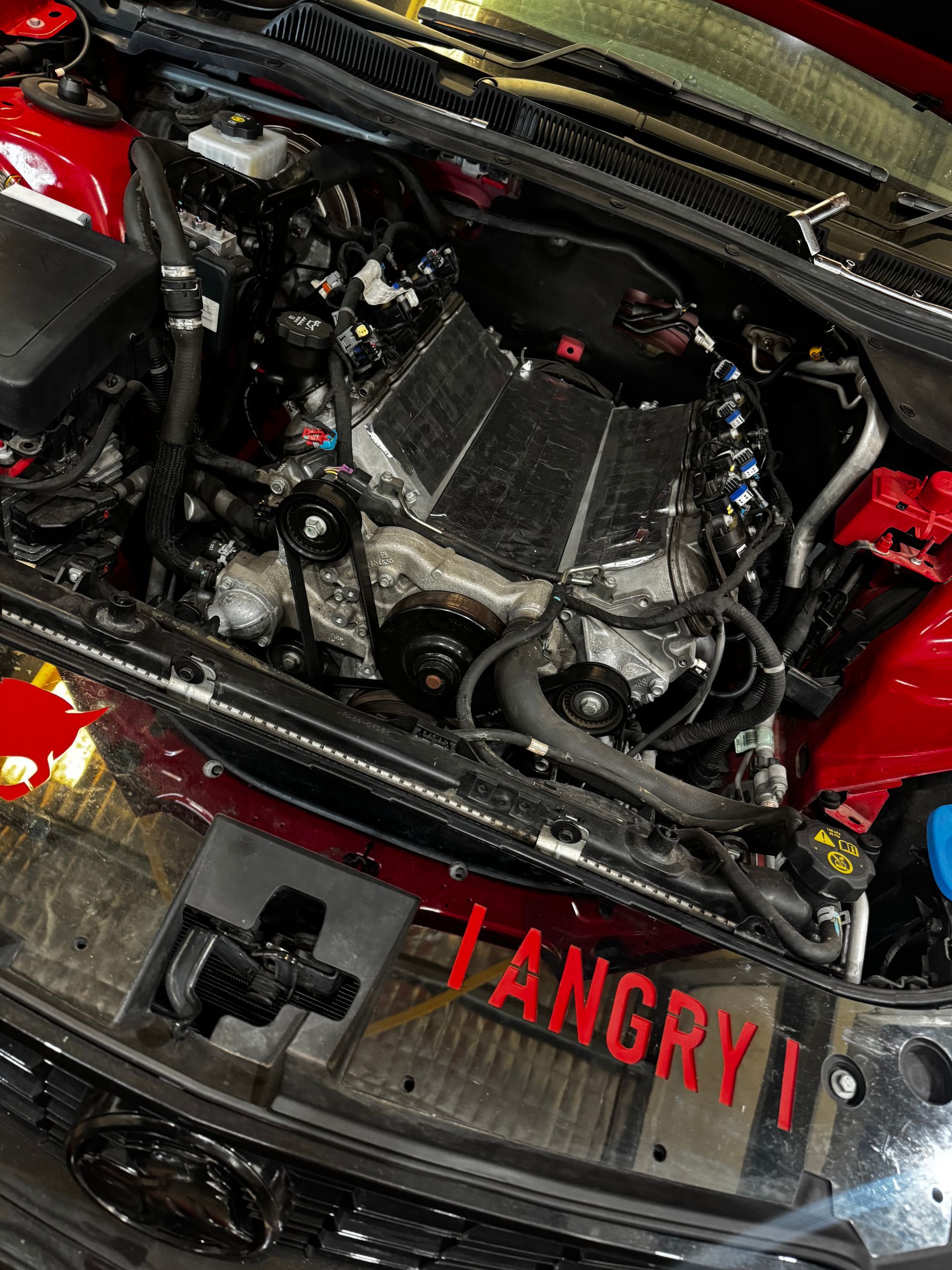 Engine Bay Of A Red Car With A Metallic Engine — Elite Fleet Auto in Bowen, QLD