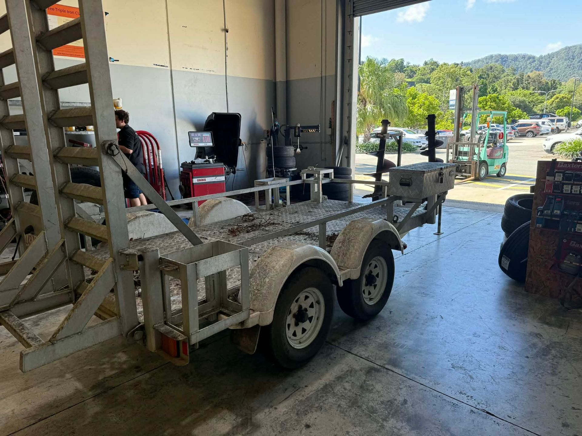 A Metal Tandem-axle Utility Trailer Parked Inside — Elite Fleet Auto in Cannonvale, QLD