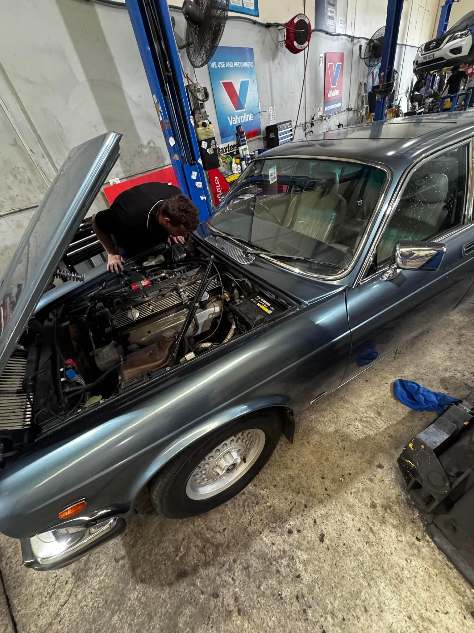 A Mechanic Leans Over The Open Engine Bay — Elite Fleet Auto in Rockhampton, QLD