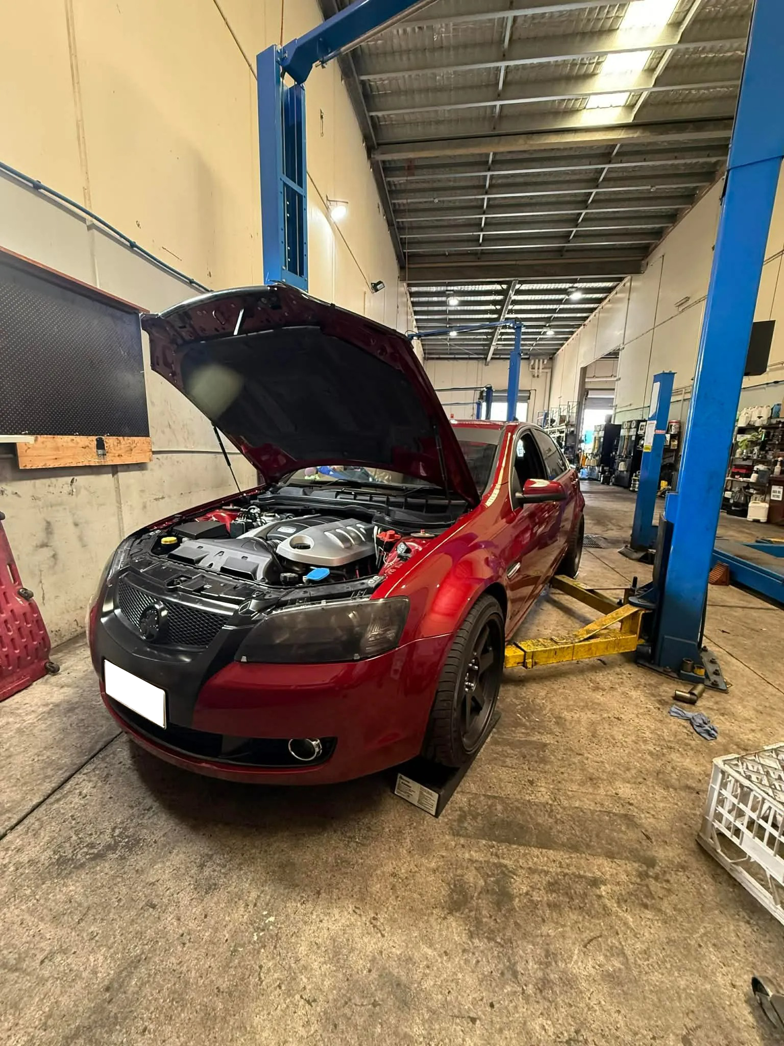 A Red Car With Its Hood Open, Parked In A Professional — Elite Fleet Auto in Cannonvale, QLD
