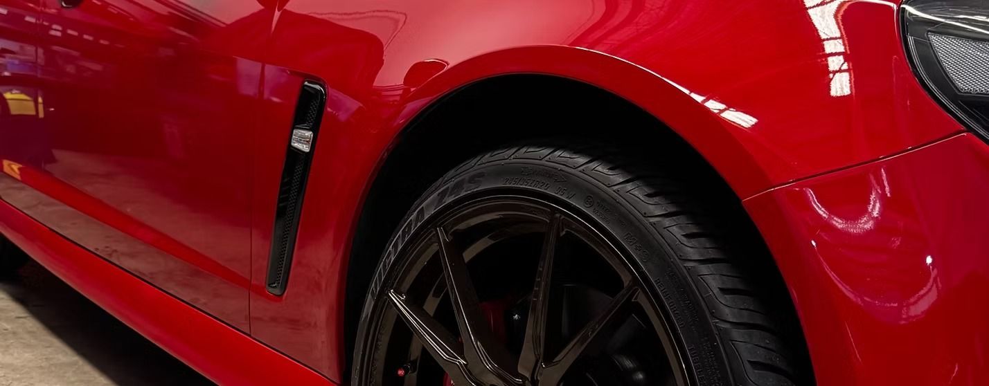 Red Car's Side, Showing Wheel, Black Trim, and Glossy Paint — Elite Fleet Auto in Mackay, QLD