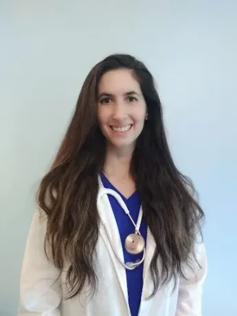 Meet Westminster, MD's Top Chinese Medicine Doctor. Dr. Brianna Livesay Thayakaran Smiling in lab Coat | Top Chinese Medicine and Holistic Doctor in Westminster, MD