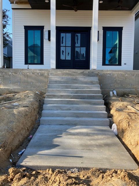 A concrete sidewalk with entry stairs in Brandon, MS by Scott Meadows Construction Co. 