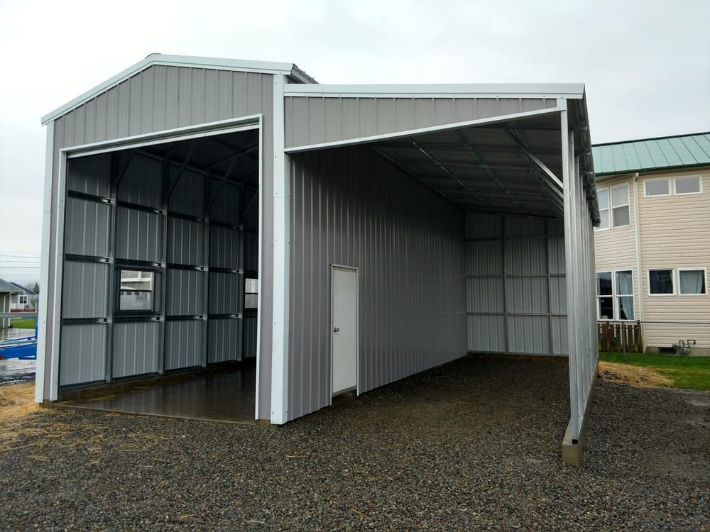 A metal garage with a white door and a white roof