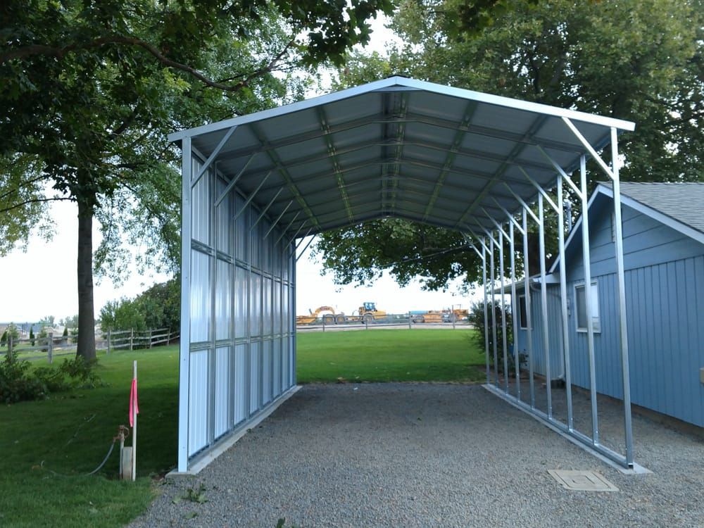 A carport with a blue house in the background