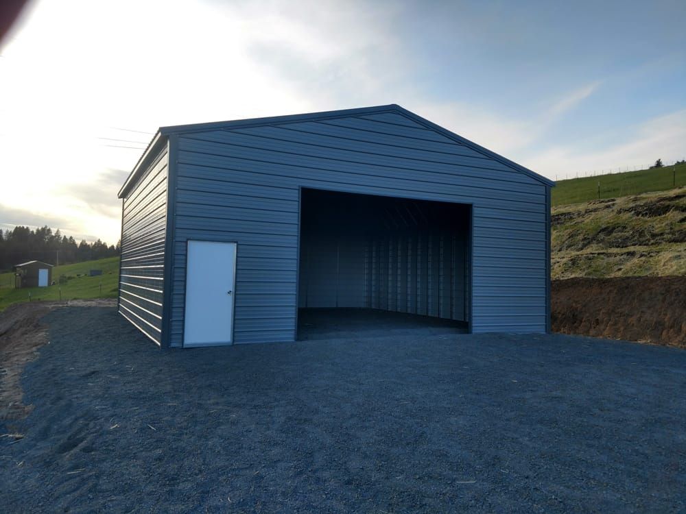 A gray metal garage with a white door