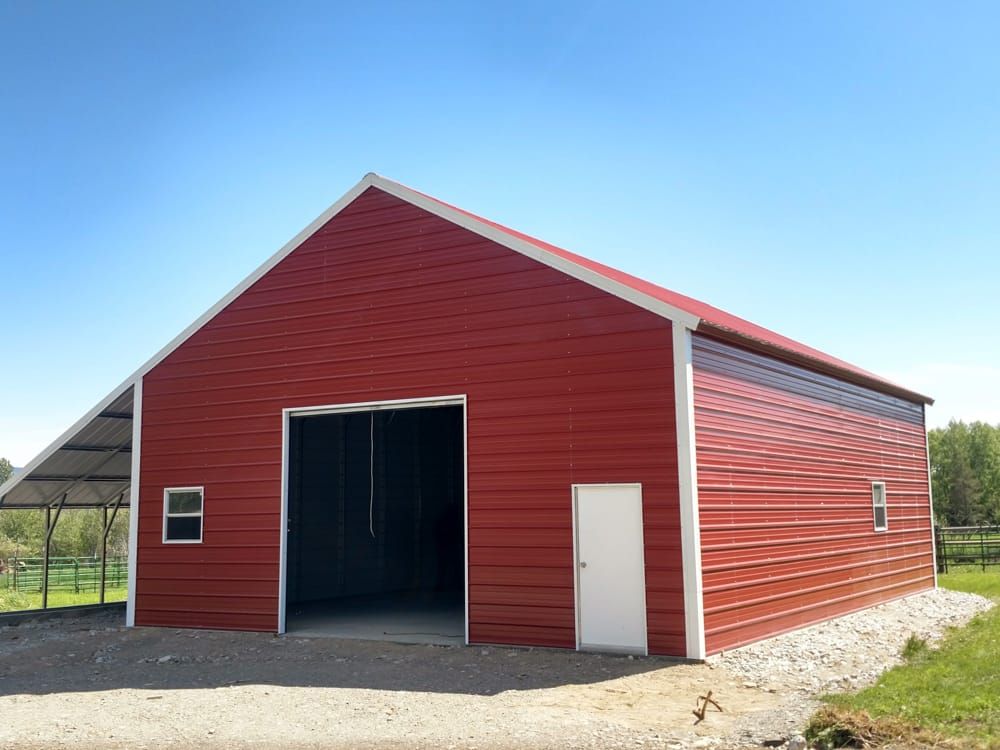 A red barn with a white trim and a white door