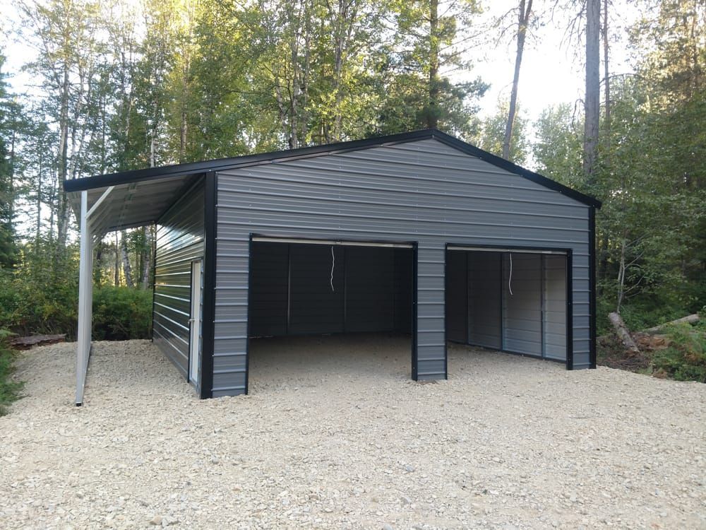 A gray metal garage with a canopy on top of it