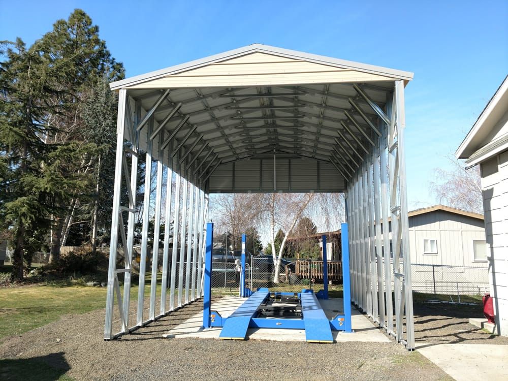 A carport with a blue lift inside of it