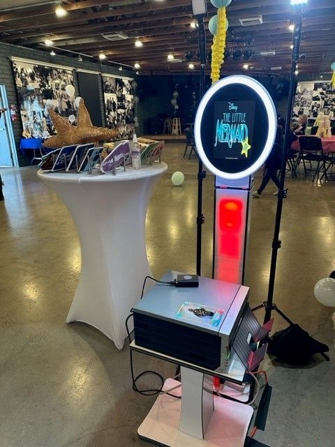 A photo booth is sitting in the middle of a room.