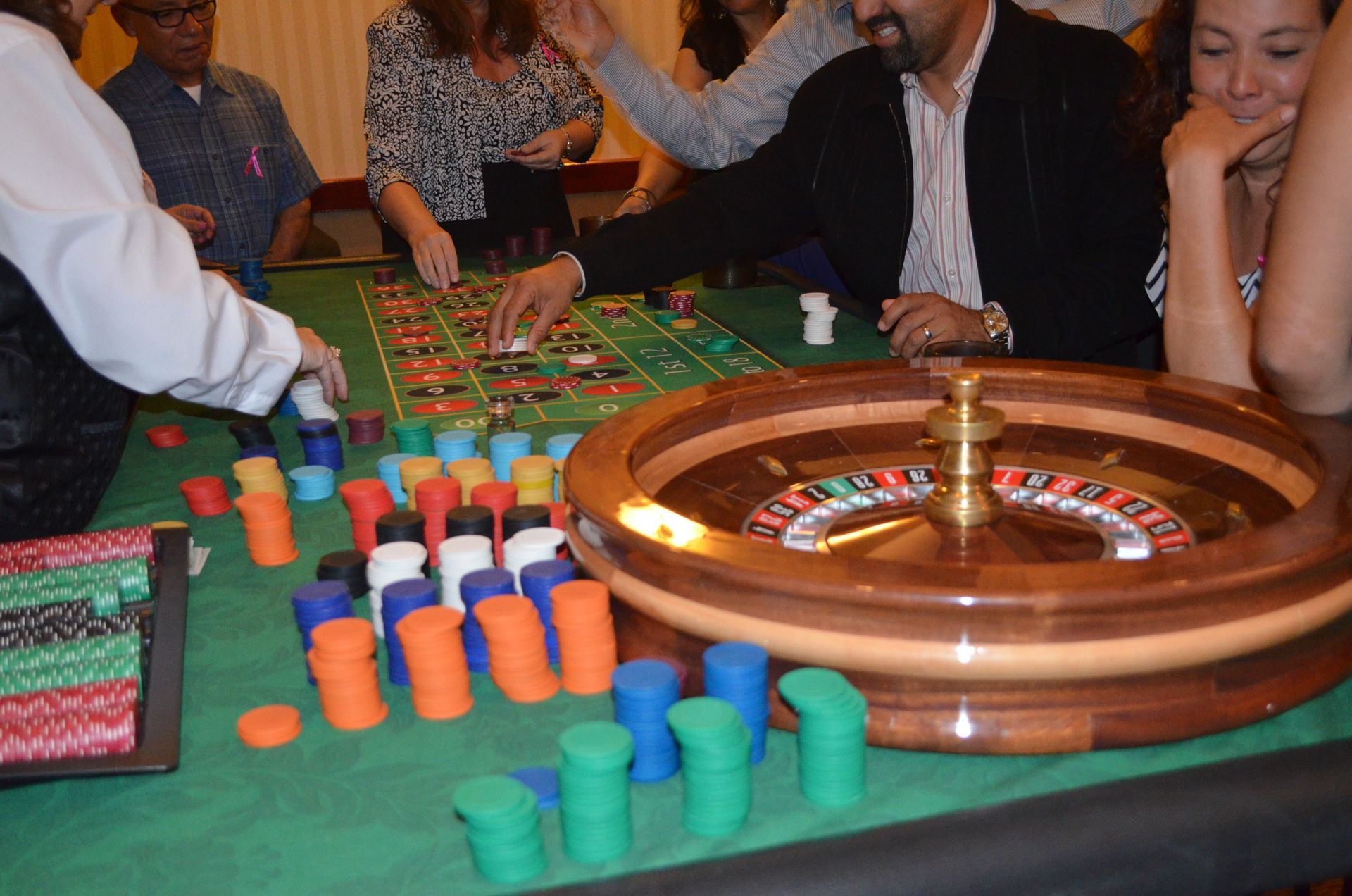 A group of people are playing roulette in a casino