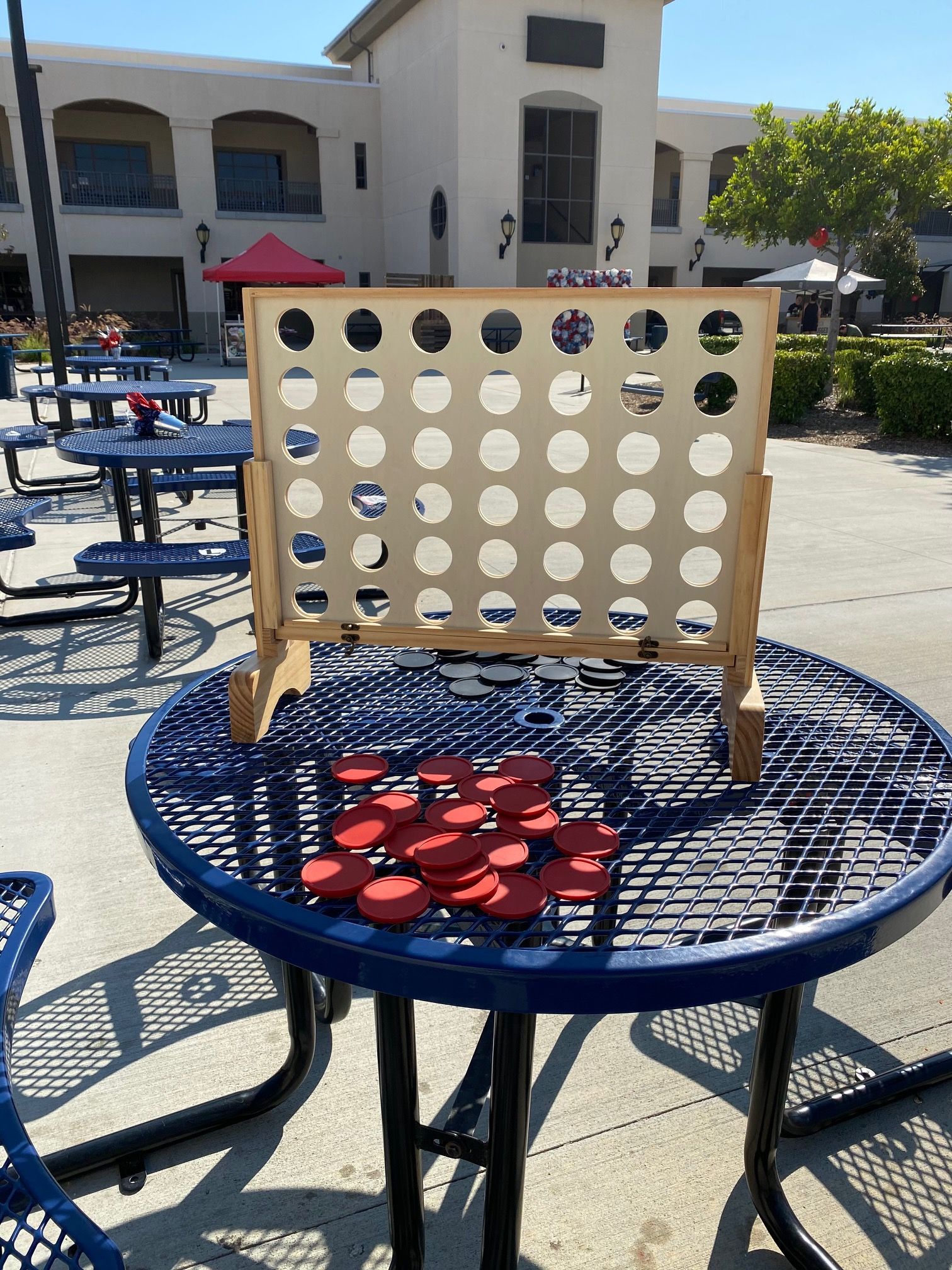 A picnic table with a connect four game on it