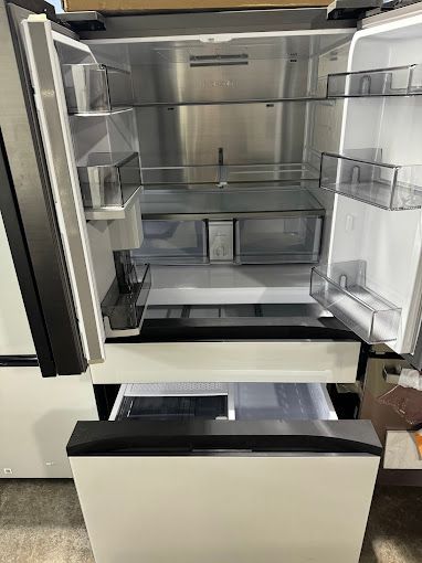 The inside of an empty refrigerator with the door open.