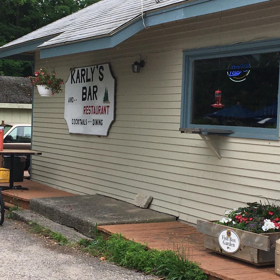 A sign on the side of a building that says karly 's bar