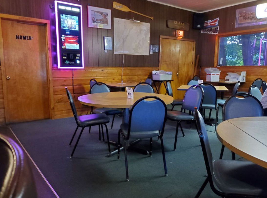 The inside of a restaurant with tables and chairs