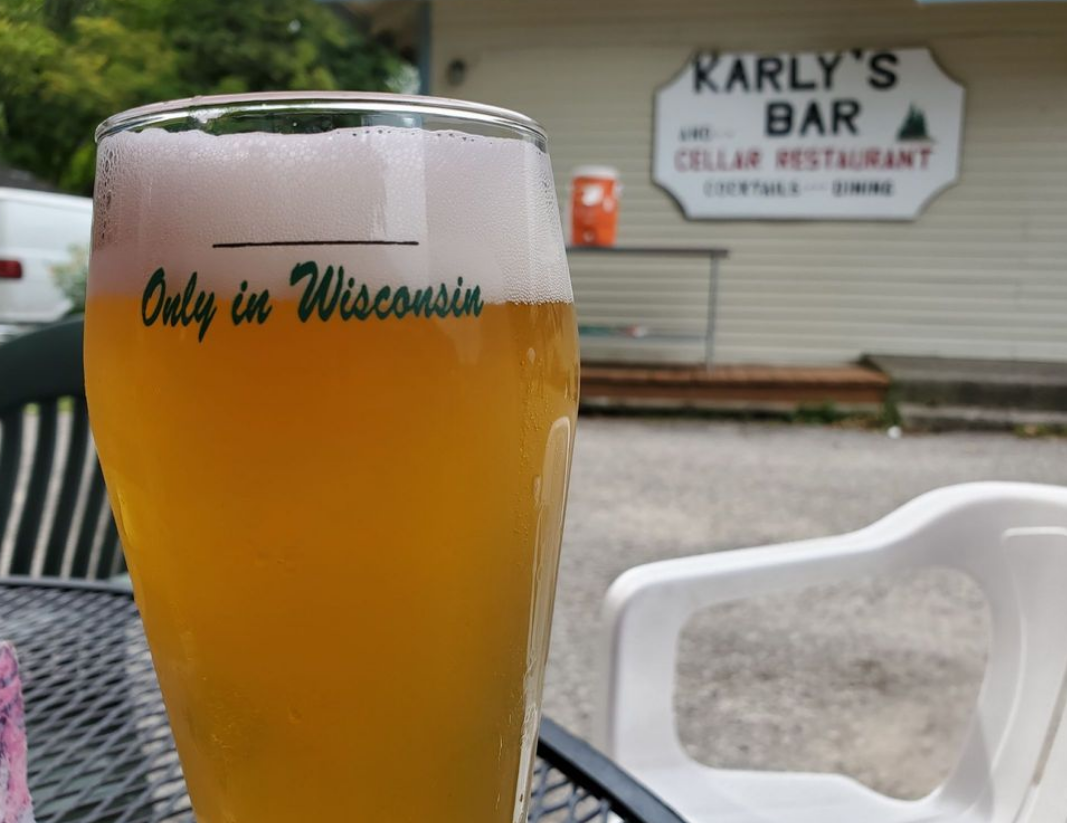 A glass of beer that says only in wisconsin