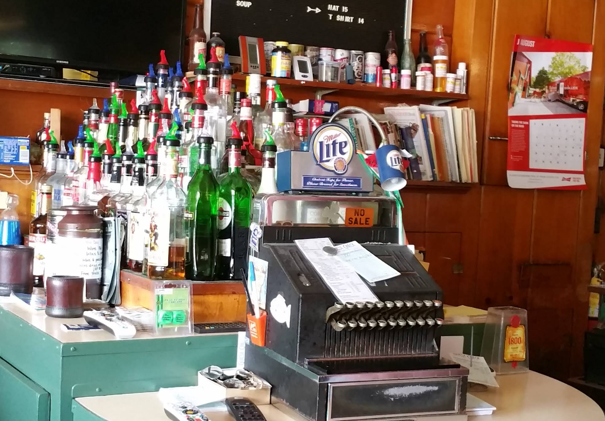 A bar with a miller lite sign on the counter