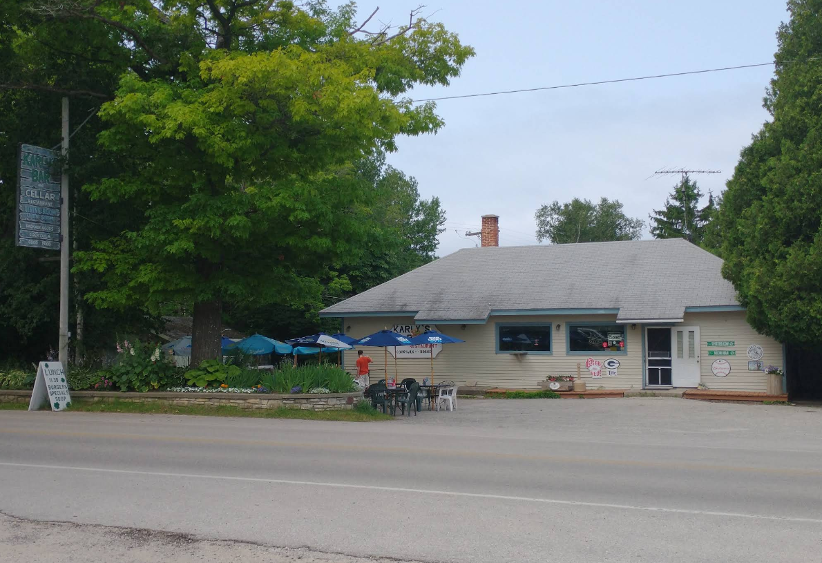 A small building with umbrellas in front of it