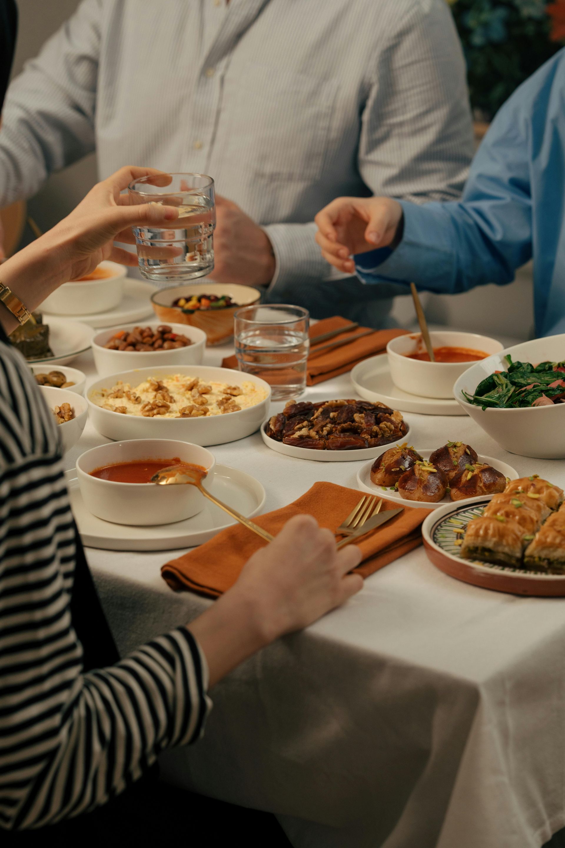 A group of people are sitting at a table eating food.