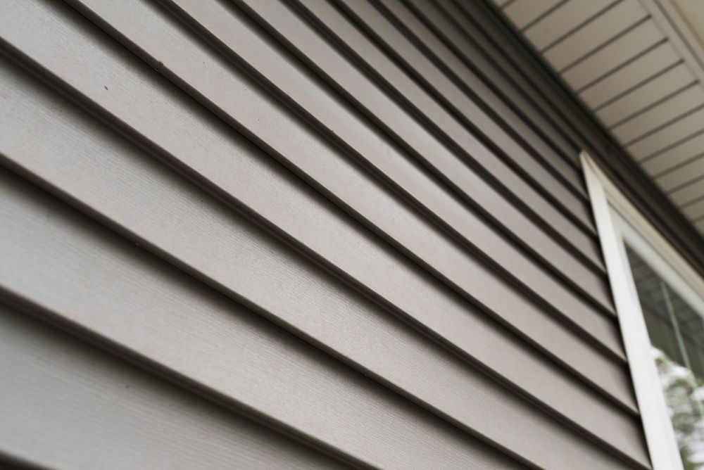 A close-up of a siding on a house with a window