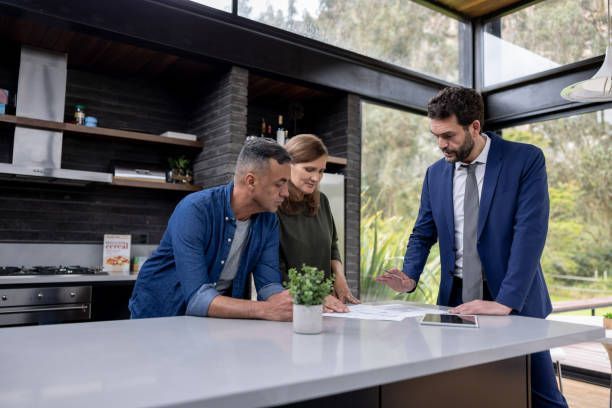 Couple Signing Document Policy — Auckland, NZ — The New Zealand House Inspection Company