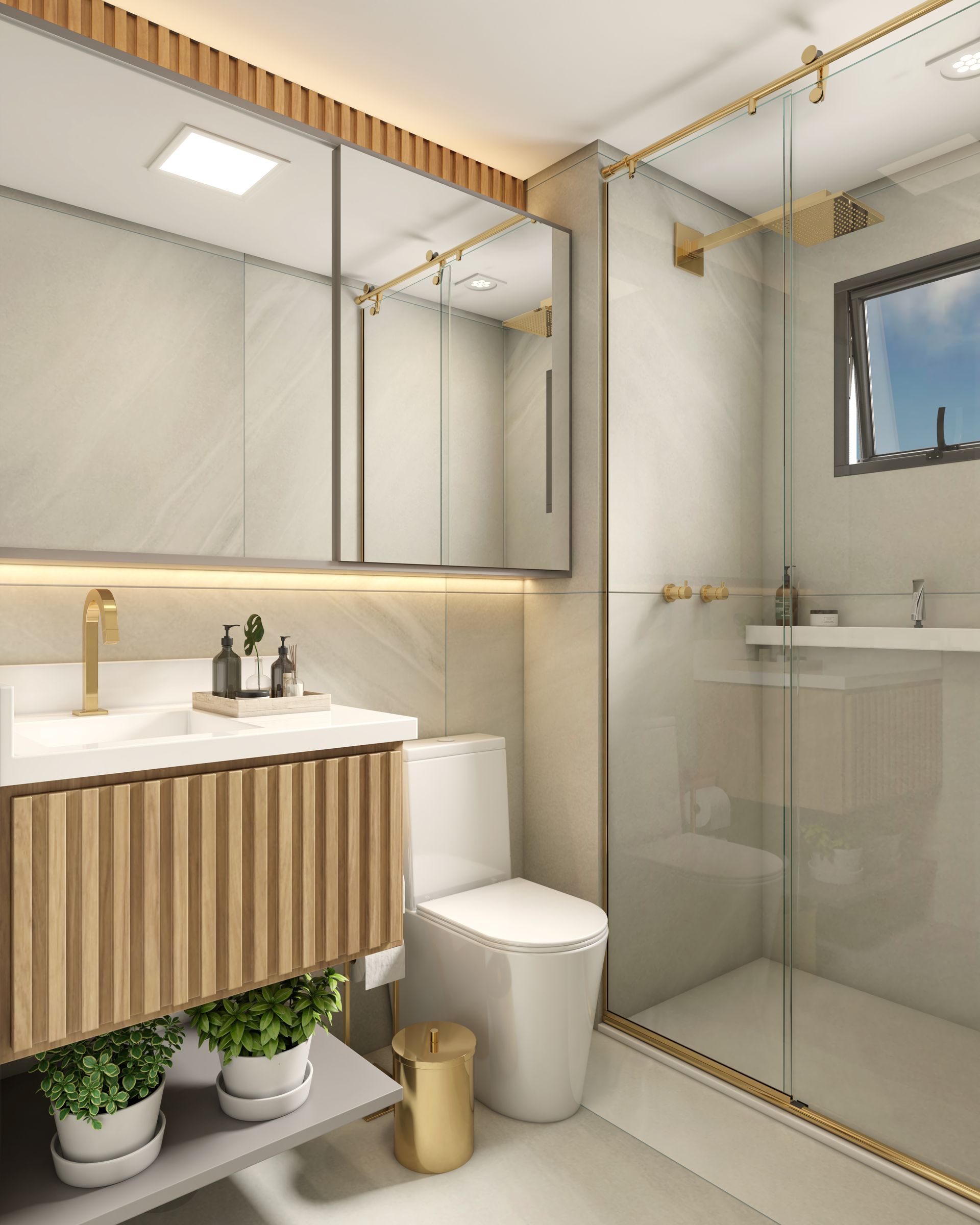 Banheiro moderno com bancada de madeira, box de vidro e acessórios dourados.