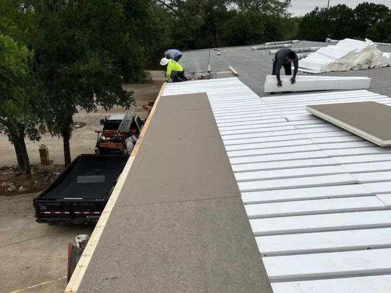 Trench dug in a grassy yard, leading to a house with black siding, and an electrical box.