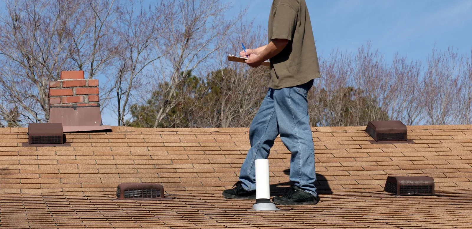 Trench dug in a grassy yard, leading to a house with black siding, and an electrical box.