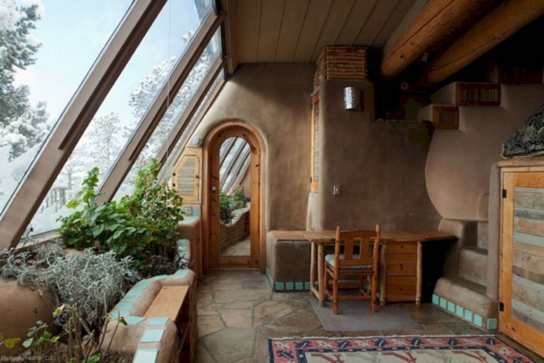 A room with a desk and chair in it and a lot of windows.