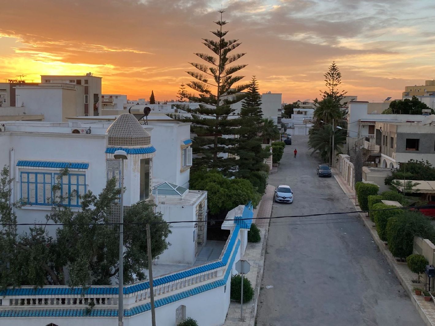 An aerial view of a city street at sunset