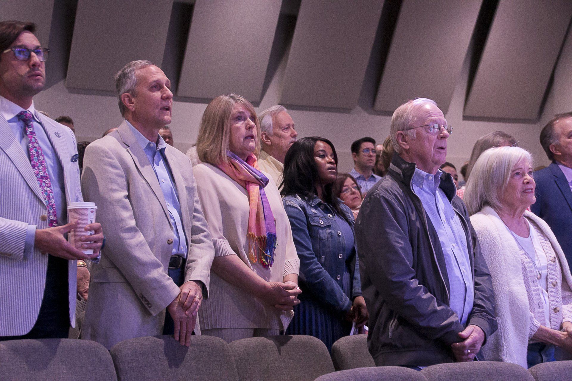 A group of people are standing in a row in a church.