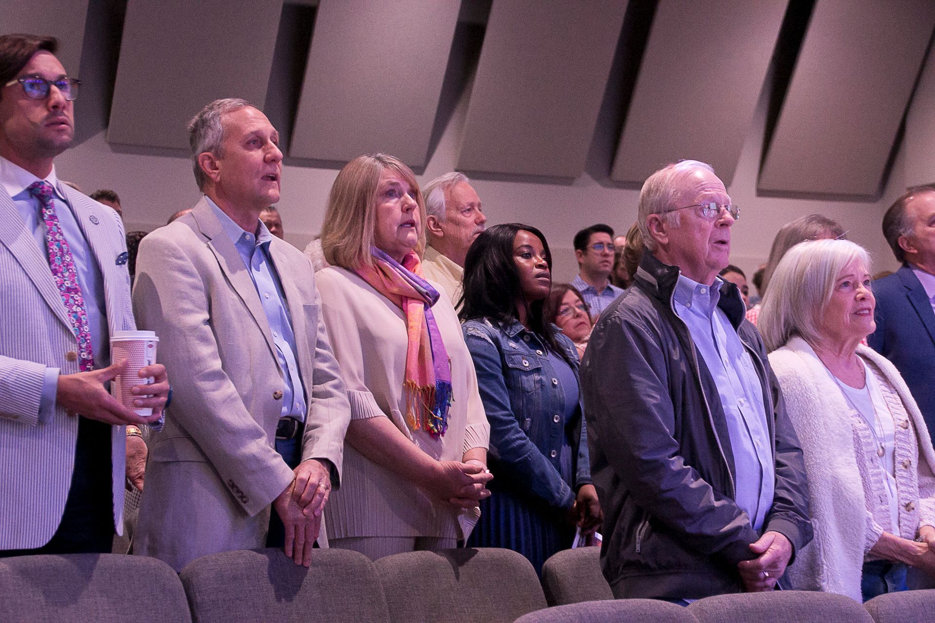 A group of people are standing in a row in a church.