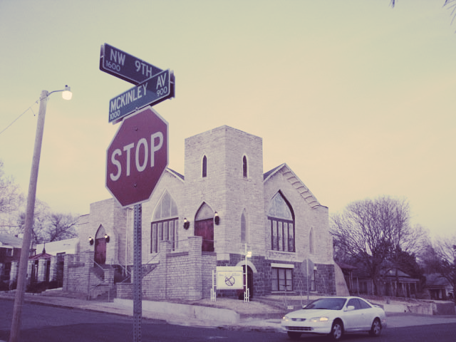 A stop sign is in front of a church