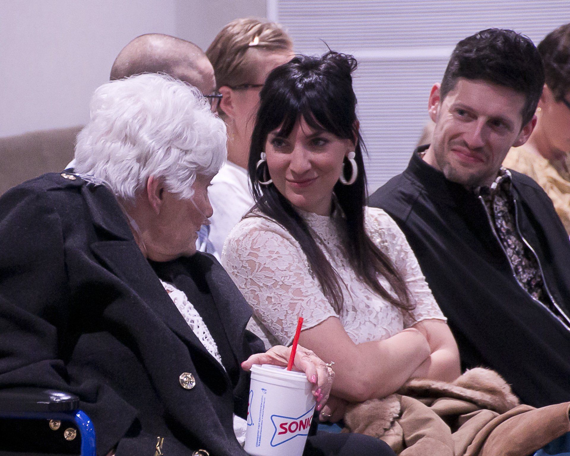 A woman is holding a cup that says sonic on it