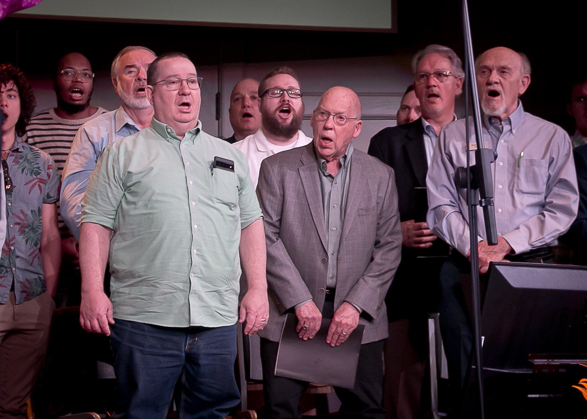 A group of men are singing together in a choir