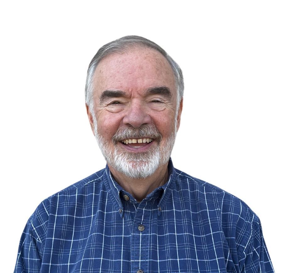 A man with a beard and mustache is smiling for the camera.
