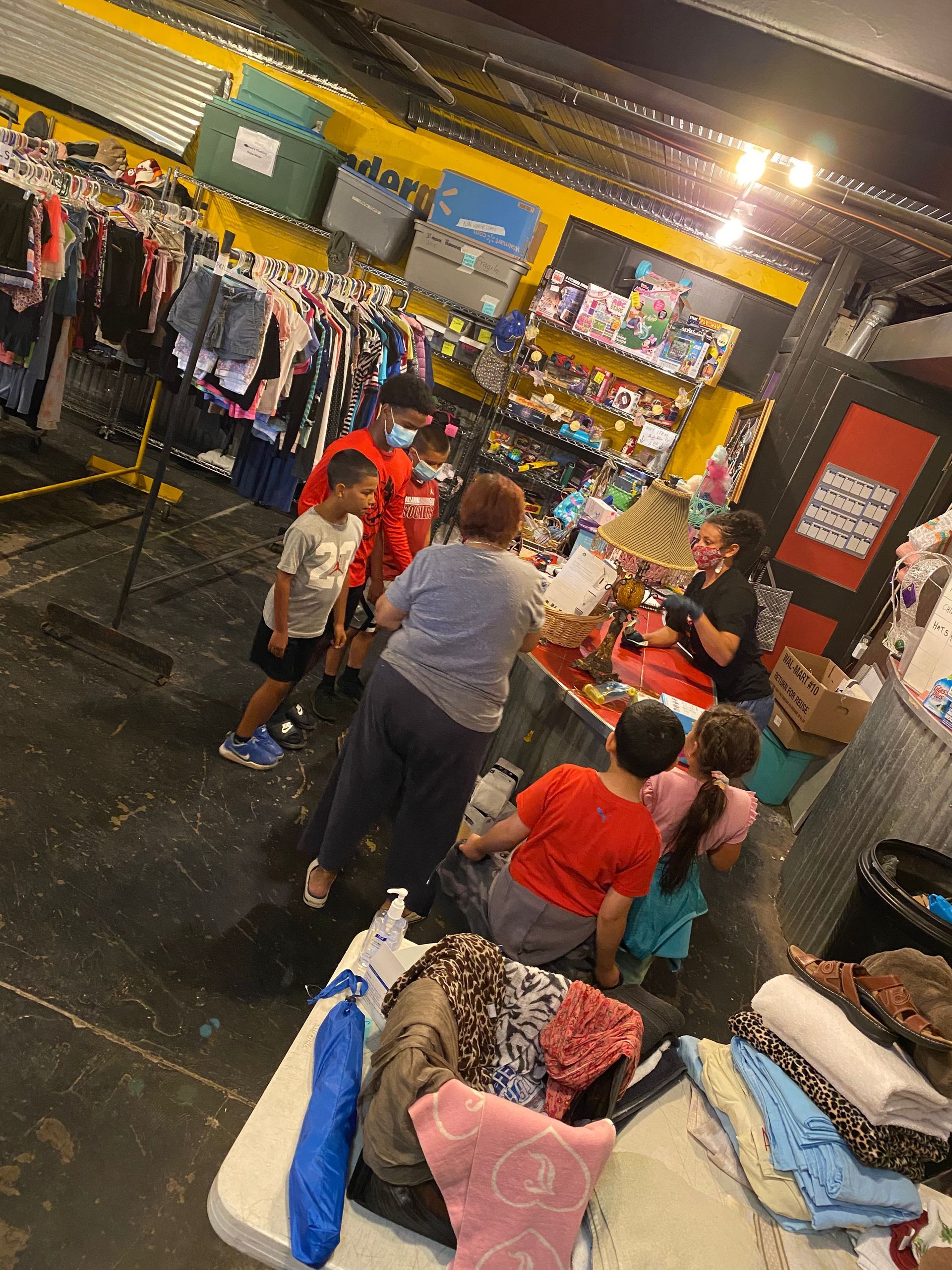 A group of people are standing around a table in a store.