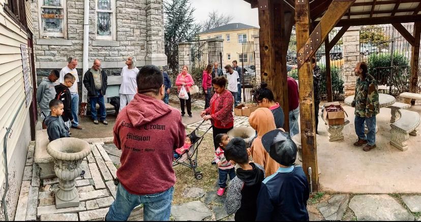 A group of people are standing outside of a building.