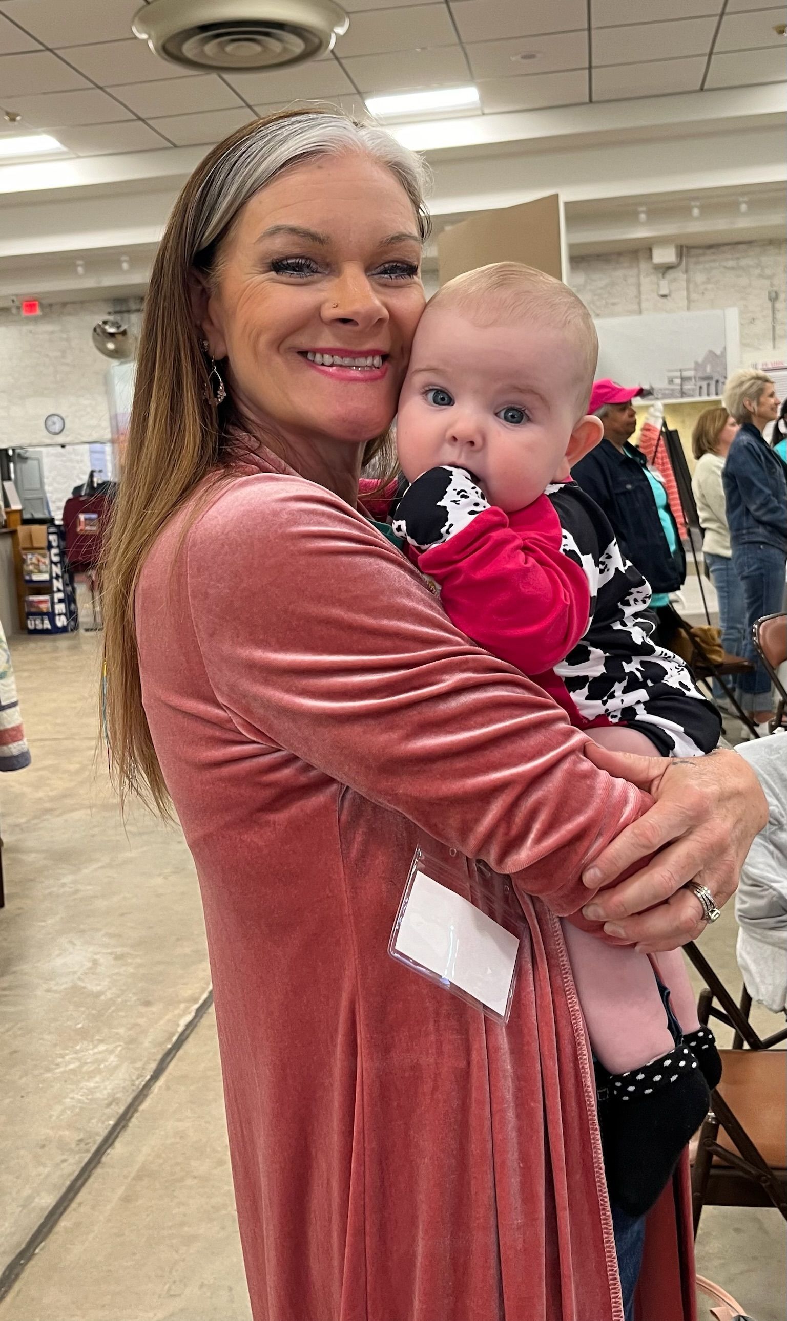A woman is holding a baby in her arms in a room.