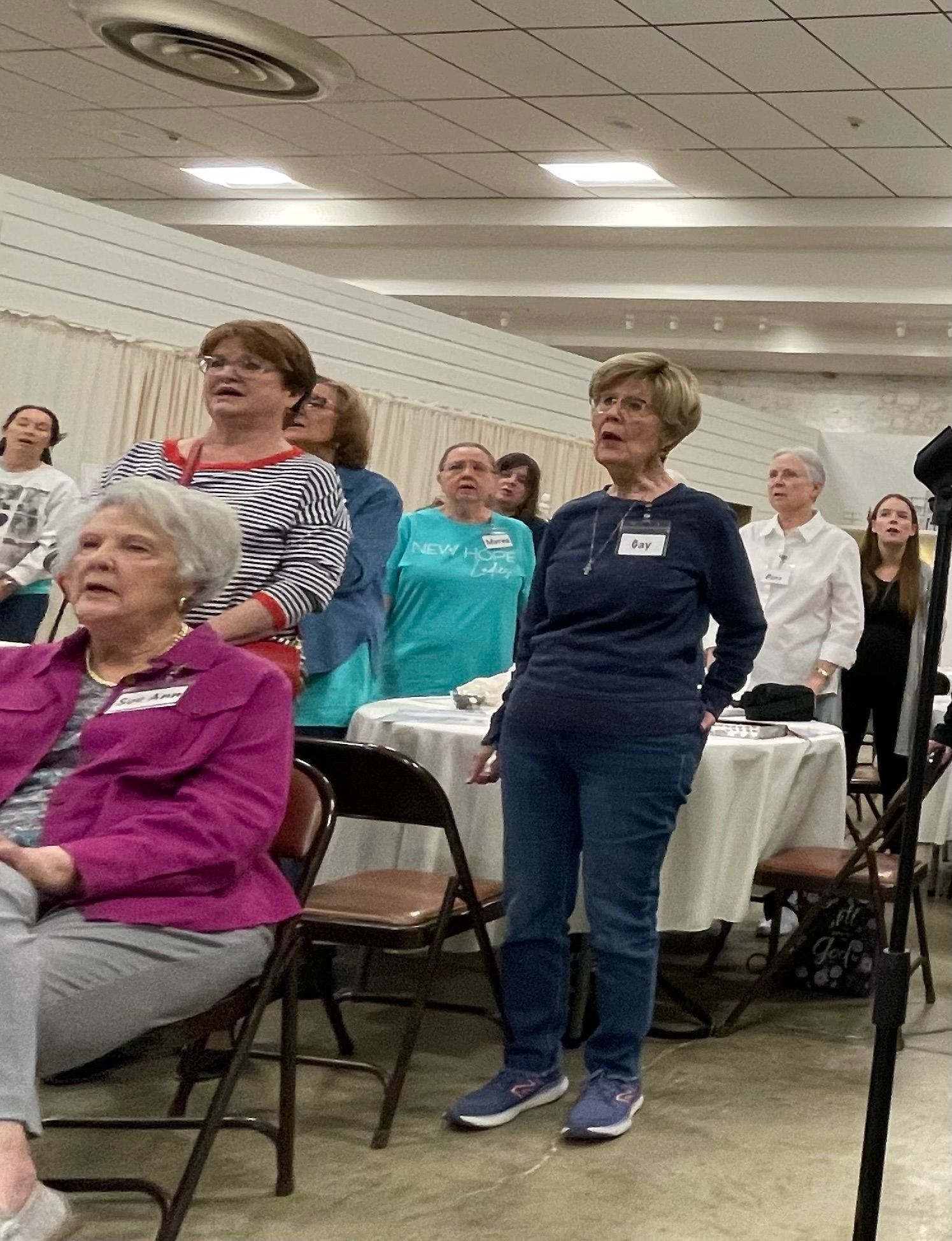 A group of women are standing in a room.