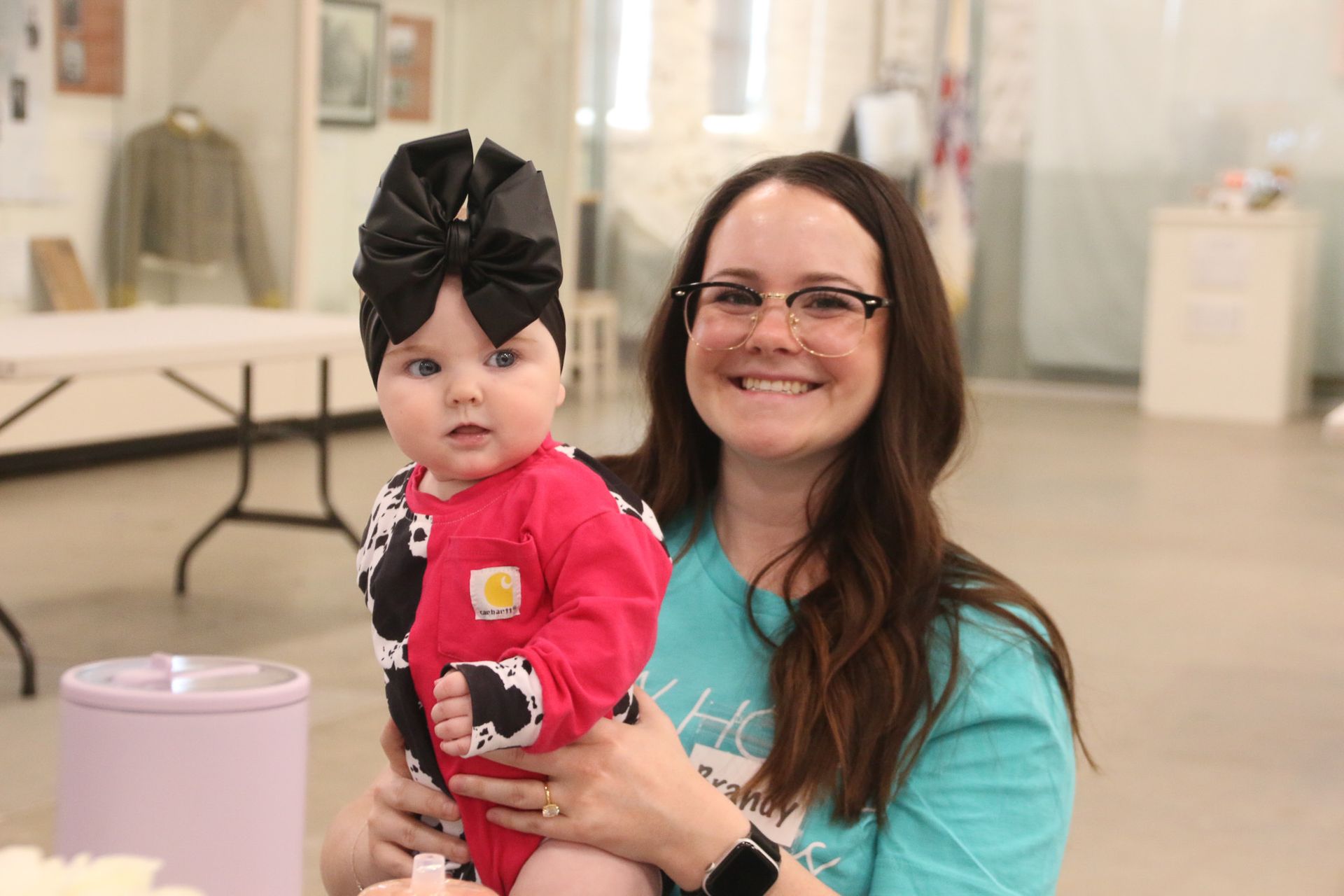 A woman is holding a baby in her arms in a room.